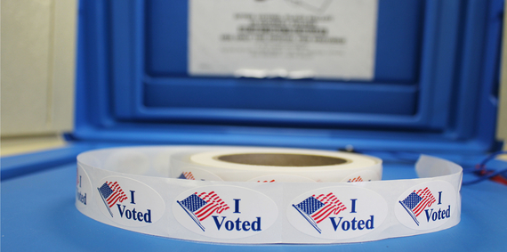 A roll of i voted stickers sitting on top of a box.