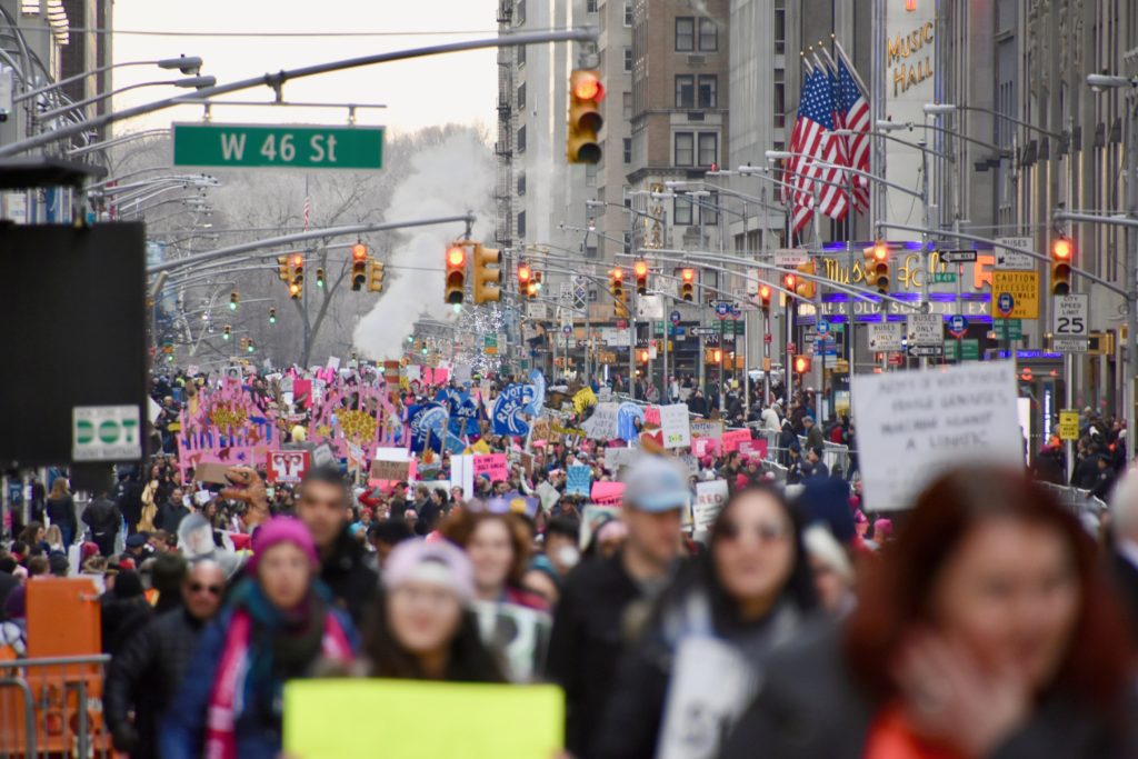 A large group of people walking down the street.