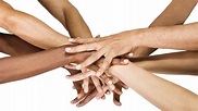 A group of people with their hands together.