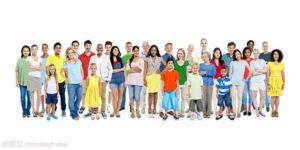 A group of people standing together in front of a white background.