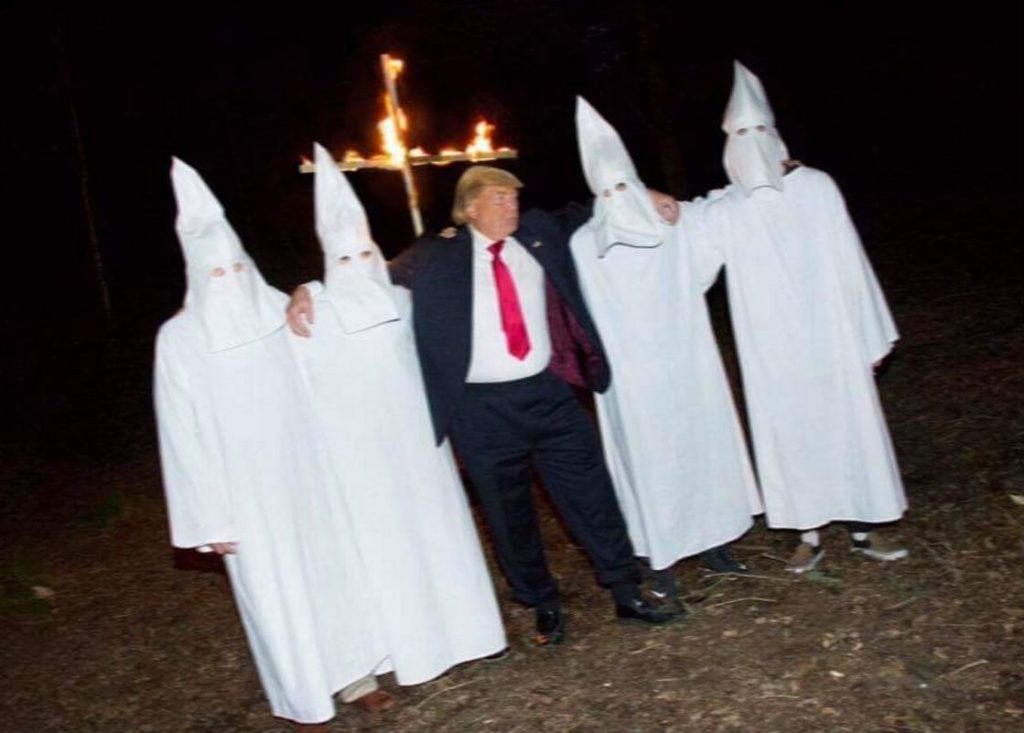 A group of people in white hoods and suits