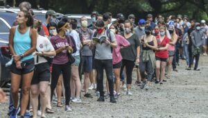 A group of people standing around each other.